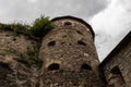 Medieval stone tower with loopholes against the background of a dark sky. Royalty Free Stock Photo