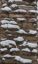 Medieval stone wall is covered with snow, design background with place for text Royalty Free Stock Photo