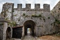 Medieval stone wall with tunnel and gate of Rozafa castle in Shkodra Albania. Ancient antique landscape with a dilapidated Royalty Free Stock Photo