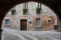 Medieval street arch under an ancient brick wall of a building facade in the town of Cividale del Friuli. Udine, Friuli Venezia