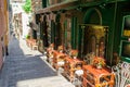 Medieval street with outdoor cafe in the Italian hill town of Genova. The traditional italian medieval historic center Royalty Free Stock Photo