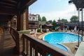 Medieval style wooden terrace overlooking the outdoor pool Decoration elements of the outdoor area of a country club Royalty Free Stock Photo