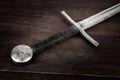 Medieval sword on wooden background Royalty Free Stock Photo