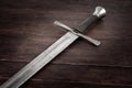 Medieval sword on wooden background Royalty Free Stock Photo