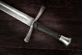 Medieval sword on wooden background Royalty Free Stock Photo