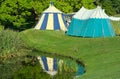 Medieval tents reflected in pond. Tudor reenactment.