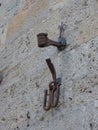 A medieval iron torch holder shaped like a hand on a stone wall in a hill town of Tuscany Italy