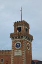 Medieval tower with beautiful clock. The Venetian Arsenal.