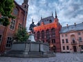 Medieval Town Hall and statue of raftsman playing the violin in Torun.