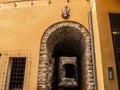 Medieval tunnel-street in the old town of Cervera Lleida, Catalonia. Arched passage with an ancient devil or goat sign on the