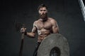 Medieval viking with axe and helmet in dark background