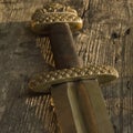 Medieval viking sword against a wooden wall