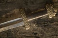 Medieval viking sword against a wooden wall