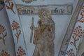 A medieval wall-painting of the virgin and martyr Saint Ursula, holding a candle Royalty Free Stock Photo