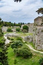 Medieval walls of Rhodes and moat under cloudy sky, Greece