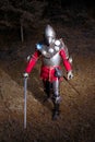 Medieval Warrior in Knight's Suit Standing in Dark Forest Ready for Battle, Full Length Shot Royalty Free Stock Photo