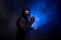 Medieval warrior ninja assassin throws shuriken in smoke