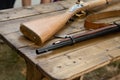 Medieval weapon musket butt and smoothbore muzzle on a wooden table Royalty Free Stock Photo