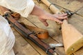 Medieval weapons with a wooden butt lies on a table close-up