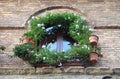 Medieval window with flowers pots Royalty Free Stock Photo