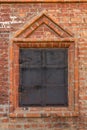 Medieval window with iron shutters in a brick wall Royalty Free Stock Photo