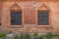 Medieval window with iron shutters in a brick wall Royalty Free Stock Photo