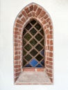 Medieval window with stained glass in historical church Royalty Free Stock Photo