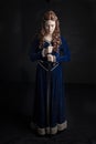 Medieval woman in a blue velvet dress Royalty Free Stock Photo