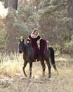 Medieval woman riding horse in forest Royalty Free Stock Photo