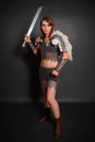 Medieval woman warrior in chain mail armor with lamellar bracers and lamellar shoulder pads with polar fox fur