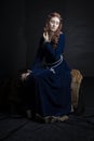 Medieval woman in a blue velvet dress