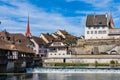 Medieval wooden bridge of Bremgarten over Reuss river with the small town at sunshine