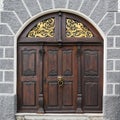 Medieval wooden door with lion head doorknocker and golden iron decoration, Ulm, South Germany