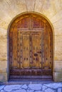 Medieval wooden door in the shape of an arch in the picturesque tourist town of Pals, Girona.