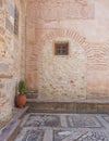 Medieval yard corner and basil in terracotta flowerpot