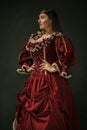 Medieval young woman in old-fashioned costume