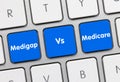 Medigap Vs Medicare - Inscription on Blue Keyboard Key Royalty Free Stock Photo