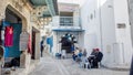 Medina of Sousse, old men chatting and drinking coffee on the street near cafe Royalty Free Stock Photo