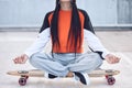Meditate, relax and woman on skateboard outdoor for freedom with streetwear, peace and concrete floor. Gen z girl, lotus