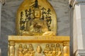 Meditating buddha golden painted statue located at National shanti stupa in Delhi. unique perspective image. symbol of peace Royalty Free Stock Photo