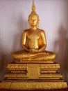 Meditating Buddha image, golden yellow illuminated