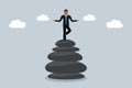 meditating business man stand on a stack of zen stones work life balance concept Royalty Free Stock Photo