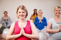 Meditating on our maternity. A multi-ethnic group of pregnant women meditating on exercise balls in a yoga class. Royalty Free Stock Photo