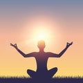 Meditating person on summer meadow at sunshine