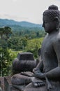 Meditating sitting Buddha sculputre in stone at Royalty Free Stock Photo