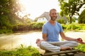 Meditation energizes him. Portrait of a handsome mature man doing yoga in a beautiful garden.