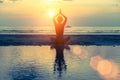 Meditation girl on the sea during sunset