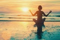 Meditation girl on the sea during sunset.