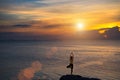 Meditation girl on the sea during sunset. Yoga silhouette.