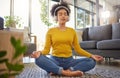 Meditation, headphones and woman in home wellness, mental health or yoga podcast in living room. Music, streaming and Royalty Free Stock Photo